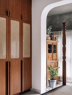 a wooden cabinet sitting next to a doorway