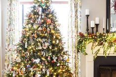 a decorated christmas tree in front of a fireplace