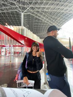 a man standing next to a woman at an airport