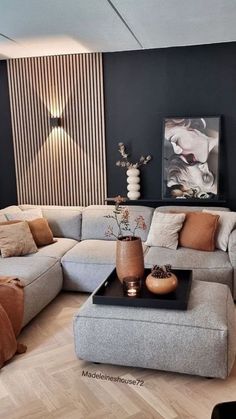 a living room filled with lots of furniture next to a wall covered in striped walls