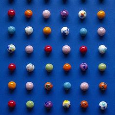 many different colored candies on a blue surface