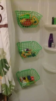 three baskets are hanging on the shower wall