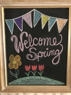 a chalkboard with the words welcome spring written on it