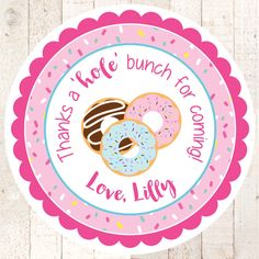 a pink and white sticker with donuts on it