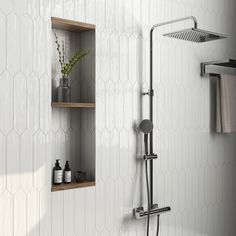 a bathroom with white tile and hexagonal tiles on the wall, including shelves