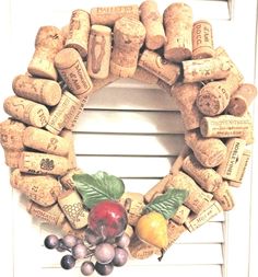 a wreath made out of wine corks and fruit