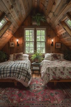 two beds in a room with wooden walls and ceilinging, along with a rug on the floor