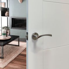 a living room with a coffee table and door handle