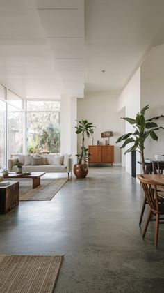 a living room filled with lots of furniture and plants on top of it's walls