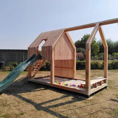 a wooden structure with a slide in the middle