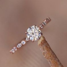 a diamond ring sitting on top of a stick