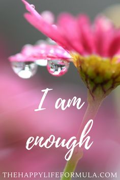 a pink flower with water drops on it and the words i am enough