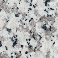 a close up view of a marble surface with black and white speckles on it