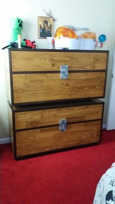 a wooden dresser sitting in a bedroom next to a red carpeted floor and white walls