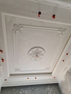 the ceiling is painted white and has red dots on it