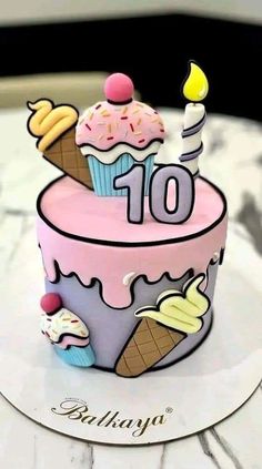 a small birthday cake with ice cream and cupcakes on it's top