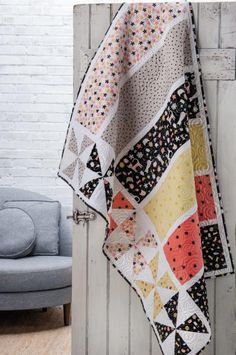 a quilt hanging from the side of a door