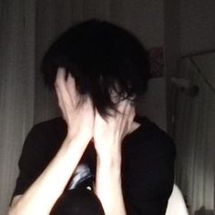 a woman covering her face with her hands