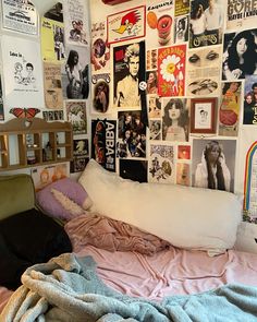 a bed with lots of posters on the wall