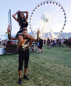 two people standing in front of a ferris wheel with the caption instagram likes