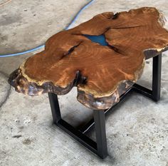 a piece of wood sitting on top of a metal stand in the middle of a floor