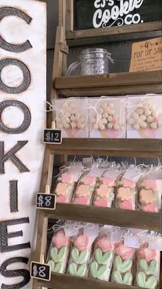 a display case filled with lots of different types of cookies on top of wooden shelves