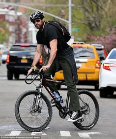 a man is riding his bike down the street