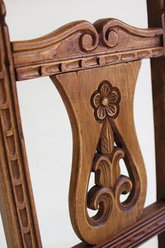 an ornately carved wooden chair against a white background