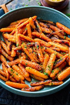 a bowl filled with cooked carrots on top of a table