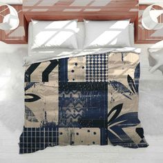 a bed covered in a blue and white quilt