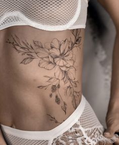 a woman with a flower tattoo on her stomach