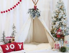 a teepee is set up with christmas decorations