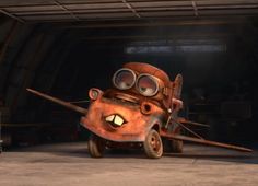 an animated character is sitting in the garage with his eyes open and nose wide open