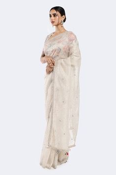 Off white saree with sequin scatter motifs. Comes with floral patterned sequined blouse. - Aza Fashions White Anarkali Blouse With Sheer Dupatta, White Blouse With Sheer Dupatta For Diwali, White Blouse For Eid Reception, White Blouse With Chikankari Embroidery For Reception, White Chikankari Embroidery Blouse For Reception, White Blouse With Sheer Dupatta For Festivals, Festive White Tissue Silk Blouse, White Pre-draped Saree With Mirror Work For Eid, White Tissue Silk Blouse Piece With Mirror Work