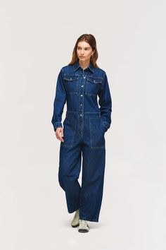 Button Front Contrast Stitching Large utility pocket features Blue Jeans With Buttoned Pockets For Work, Relaxed Fit Full-length Denim Jumpsuit With Pockets, Full-length Dark Wash Denim Jumpsuit With Pockets, Dark Wash Full-length Denim Jumpsuit With Pockets, Full Length Dark Wash Denim Jumpsuit With Pockets, Full-length Denim Blue Jumpsuit With Pockets, Full Length Denim Blue Jumpsuit With Pockets, Full Length Denim Jumpsuit With Pockets, Fall Utility Blue Denim Jumpsuit