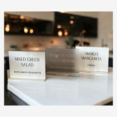 three business cards sitting on top of a counter