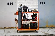 an orange cart with some tools on it