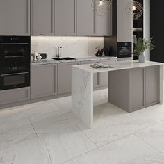 a modern kitchen with marble counter tops and grey cabinetry, along with an island in the middle