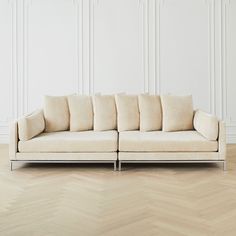 a white couch sitting on top of a wooden floor