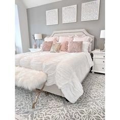 a white bed sitting in a bedroom on top of a rug