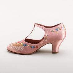 As hemlines rose in the 1920s, flashy footwear was all the rage, and the Daisy Embroidered T-Strap heels are just the ticket. Made in luminous satin heavily embroidered in a gorgeous botanical design, the Daisy T-Strap Shoes are closely based on an original pair in Bata Shoe Museum. These gorgeous shoes are accurate for the 1920s, 1930s, and 1940s, and offer our refined and stable 2.5 in / 6.3 cm Spanish heel paired with open sides and an almond toe. Wear Daisy embroidered 1920s shoes with any g 1920s Shoes, Bata Shoes, American Duchess, T Strap Shoes, Silk Stockings, T Strap Heels, Botanical Design, Fabric Shoes, Strap Shoes