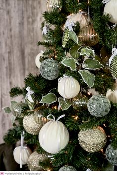 a christmas tree decorated with white and green ornaments