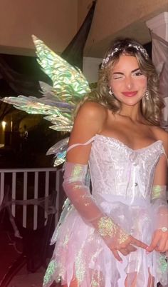 a woman in a fairy costume posing for the camera