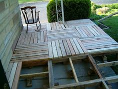 a wooden deck is being built in front of a house