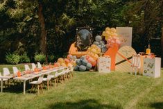 an outdoor party setup with balloons and decorations