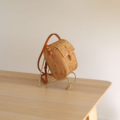 Exude timeless elegance with the Bali Rattan Crossbody Bag - Postman Messenger Bag. Crafted from the finest Ata grass and real leather, this handcrafted piece features a compact yet practical design. The adjustable strap, made from nude real leather, allows for effortless carrying of your essentials in style. This bag gracefully sits at your side, complementing your outfit with sophistication. Rattan Bag Bali, Eco-friendly Rattan Straw Bag With Adjustable Strap, Basket-shaped Rattan Shoulder Bag With Woven Leather, Eco-friendly Rattan Basket Shoulder Bag, Eco-friendly Rattan Shoulder Bag With Open Weave, Rattan Bag, Cat Hat, Online Accessories, Large Bags