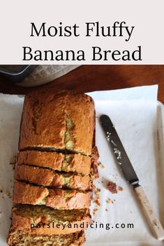 a loaf of banana bread sitting on top of a cutting board next to a knife