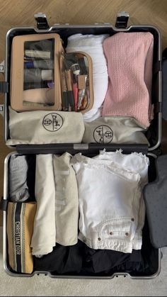 an open suitcase filled with clothes and other items