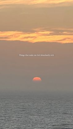 the sun is setting over the ocean with an inspirational quote