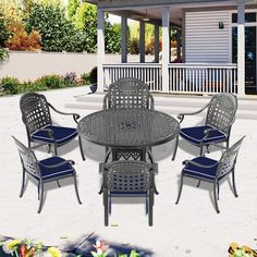 an outdoor dining table and chairs with blue cushions